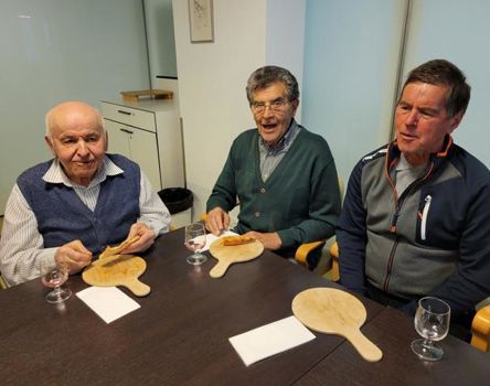 Drei Männer lassen sich die Pizza schmecken